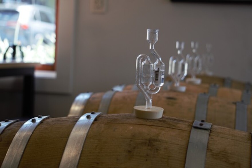 Beers ferment away in barrels inside the taproom of Pittsford's Copper Leaf Brewing.