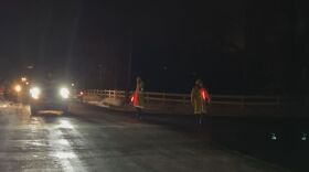 Police direct traffic away from the helicopter crash site in Mendon on Wednesday night.