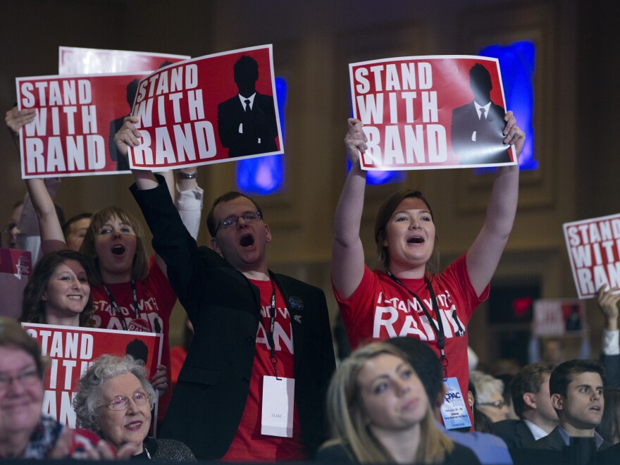 Supporters of Sen. Rand Paul cheer as he speaks during CPAC.