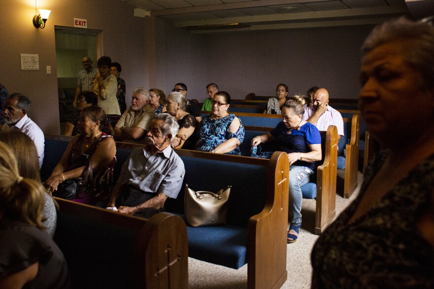 Family and friends attend the funeral of Angélica Irizarry at the Funeraria Boneta in Lares. Because of the damage in the cemetery, Irizarry's son had to bury her in Camuy, 40 minutes away.