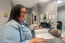 Tina Hickman, of Choctaw, Mississippi, flips through the course catalog for Bay Mills Community College, the tribal college she attended to earn her bachelor’s degree.