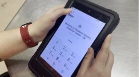 An Oklahoma County Detention Center detainee uses a tablet to send messages and video visits.