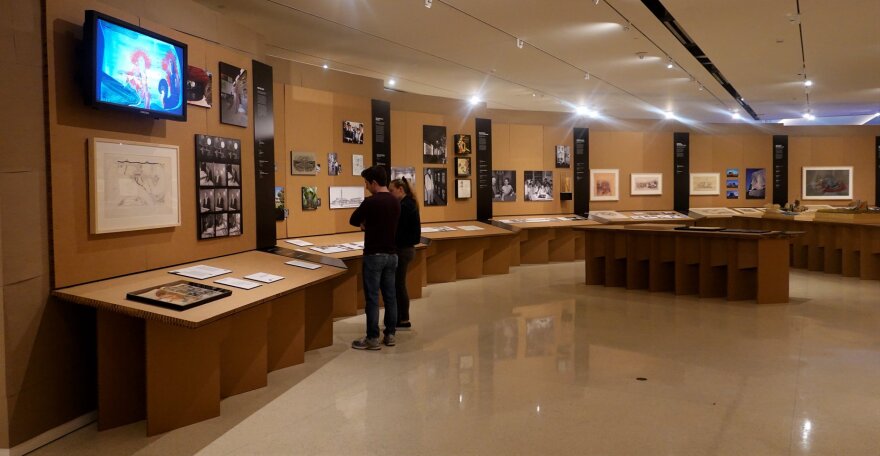 Visitors at the exhibition Renegades: Bruce Goff and the American School of Architecture at the Fred Jones Jr. Museum of Art view the "Bruce Goff" panel of the exhibition in January.