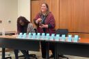 Christa Miller, Lancaster County’s election director, shakes a bottle filled with red, numbered marbles to determine the winner of tied races.