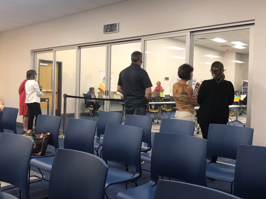 Members of the public watch Wake County Board of Elections staffers prepare mail-in ballots for counting at a weekly meeting on May 3, 2022, two weeks prior to Primary Election Day.