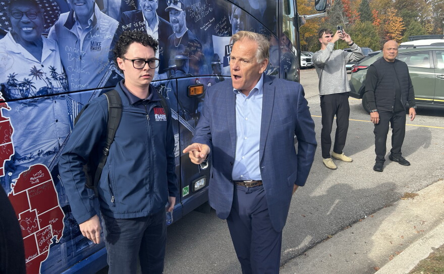 Former congressman and Republican candidate for Michigan's U.S. Senate seat Mike Rogers walks off his campaign bus before attending an event hosted by the Northern Michigan Chamber Alliance on Friday, Oct. 23, 2026.