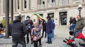 Justin Blake (center with bullhorn) holds a small rally outside the Kenosha County courthouse Monday during jury selection in the Kyle Rittenhouse trial.