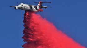 An air tanker makes a drop on the Alisal Fire Thursday.