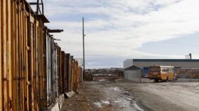 A row of shipping containers used to store contaminated material near Bethel High School on Tuesday, April 1, in Bethel, Alaska. (Photo by Rashah McChesney/Alaska's Energy Desk)
