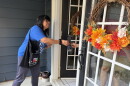 Melissa Molina, a member of Grassroots Resistance, hands literature about candidates the organization supports to a resident in Bay Village a week before the election.