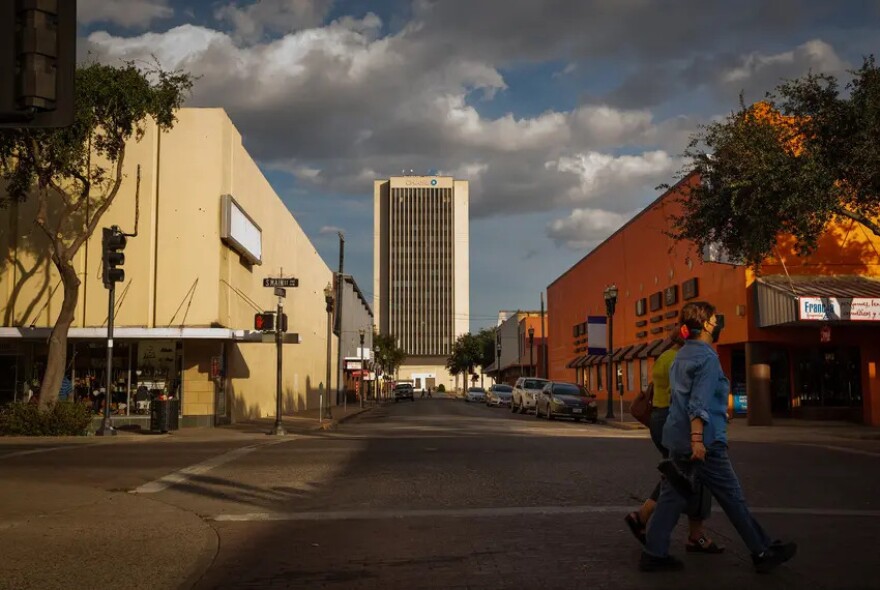 Pedestrians walk in downtown McAllen on Oct. 31, 2021. Federal funding cuts led to the cancellation of this year's Operation Border Health, a multi-county free health clinic event that serves thousands of people in the Rio Grande Valley. 