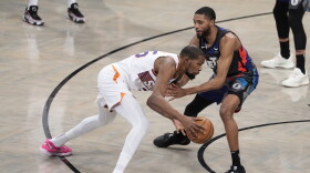 Phoenix Suns forward Kevin Durant, left, drives against Brooklyn Nets forward Mikal Bridges during the first half of an NBA basketball game, Wednesday, Jan. 31, 2024, in New York. (AP Photo/Mary Altaffer)