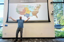 Nick Hylla, executive director of the Midwest Renewable Energy Association, explains why the cost of electricity has soared in the past five years during a presentation at the Bloomington Public Library.