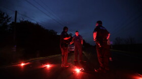 A man talks with officers at a roadblock less than three miles from the Arkema Inc. chemical plant Thursday, Aug. 31, 2017, in Crosby, Texas. The Houston-area chemical plant that lost power after Harvey engulfed the area in extensive floods was rocked by multiple explosions early Thursday, the plant's operator said. (Gregory Bull/AP)