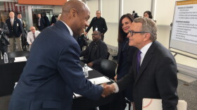 Gov. Mike DeWine (right) shakes hands with Ronnie Dunn, associate professor at Cleveland State University and a member of the Ohio Collaborative Community-Police Advisory Board. 
