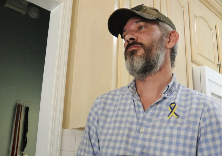 Alex Drueke, ecently released from three months of Russian captivity, pauses during an interview at home in Tuscaloosa, Ala., on Friday, Sept. 30, 2022. Drueke and fellow Alabamian Andy Huynh were captured after traveling to Ukraine to help in the fight against Russian invaders. (AP Photo/Jay Reeves)