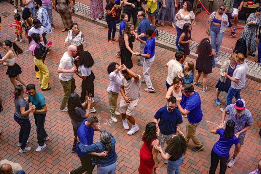 Salsa lovers dance on the bricks of Pratt Street in downtown Hartford during one of five Pratt Street Salsa Socials being held this summer. The free events are open to the public and organizer Chip McCabe of the Hartford Business Improvement District said the socials have hosted up to 1000 people, “If you want to just be able to experience community and experience an event where everybody's smiling, this is that event,” said McCabe.