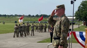 Maj. Gen. Christopher Beck salutes passing troops during the change of command ceremony where he took over at Fort Leonard Wood in the Missouri Ozarks.