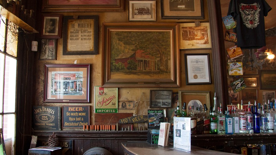 Sold signs and bottles scattered in the interior of the Genoa Bar. 