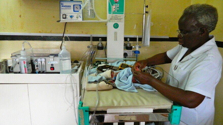 A nurse attaches the low-cost breathing machine (far left) to an infant at The Queen Elizabeth Central Hospital in Blantyre, Malawi.