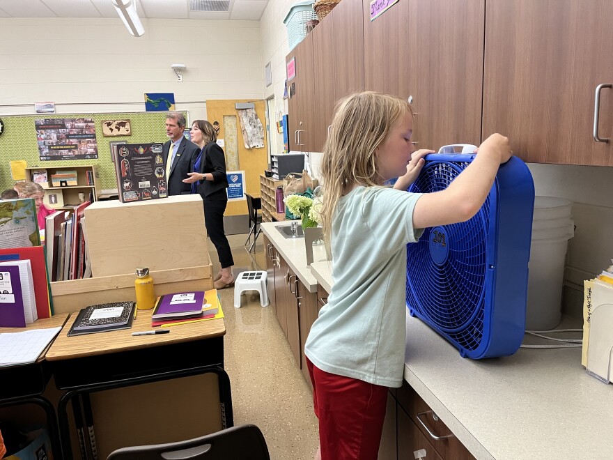 A student at Maryland Avenue Montessori turns on a fan, on the first day of school. Temperatures were expected to reach about 90 degrees, and most MPS schools do not have air conditioning.