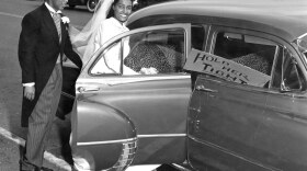 A newlywed bride and groom from 1955. Rashida Robinson reports these are her grandparents, Howard Rhone and Deloris Berry Rhone. Robinson writes: I just spoke with my grandmother and she remembered every detail about this photo, down to the leopard seats 