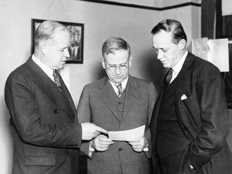 From left: Frank C. Walker, Harold L. Ickes and Harry L. Hopkins talk before making a radio address to explain the new works program on May 16, 1935.