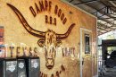 Nick Dampf stands in front of the barrel-shaped smokers at his Michelin award-winning, Texas-style barbecue food truck in Cary, N.C.