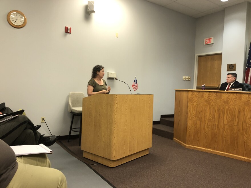 Lindie Keaton speaks at a podium in front of the Greene County Board of Commissioners in the Greene County town hall room. She is a member of the Greene County Coalition for Compassionate Justice, and argued that the county should spend their money on diversionary programs instead of building a bigger jail.