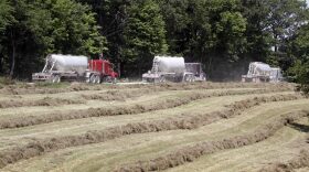 In this photo made on Wednesday, July 27, 2011, a caravan of tanker trucks take away the water mixture used in the hydraulic fracturing process in the Marcellus Shale layer to release natural gas was underway at a Range Resources site in Claysville, Pa. (Keith Srakocic/AP)