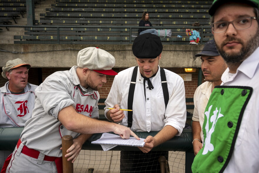 From left to right, Tom Hoepfner, Danny Gallagher, Nicholas Frandsen Charlie Magnolia, and Dave Macuga huddle in the dugout in Muzzy Field in Bristol, CT at the Historic All-Star Baseball Game where players from across the northeast come to play using rules from the 1860s.