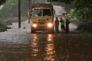Members of the Hawaiʻi Army National Guard work with other emergency officials as rainwater from nearby Hurricane Nolo floods a section of Māmalahoa Highway Saturday, Sept. 26, 2026, near Naʻālehu, Hawaiʻi Island.