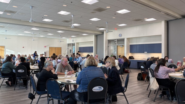 Groups of Columbia residents sit around circular tables at a meeting of the Steering Committee on Homelessness on August 27, 2026.