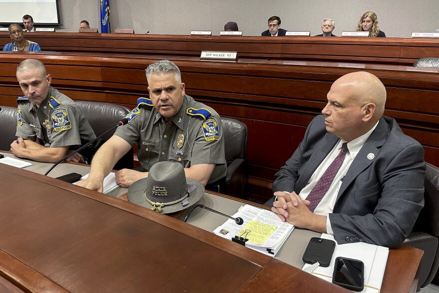 Connecticut Department of Emergency Services and Public Protection Commissioner James Rovella, right, appears with Col. Stavros Mellekas, superintendent of the Connecticut State Police, center, and Lt. Col. Mark Davison for a hearing on state troopers providing false traffic stop information on Wednesday, July 26, 2023, in Hartford, Conn. Rovella and Mellekas will be stepping down in the middle of multiple investigations into whether troopers submitted bogus data on thousands of traffic stops that may have never happened, Gov. Ned Lamont announced Wednesday, Oct. 4, 2023. (AP Photo)