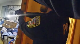 This still image from body-worn camera video, provided by the Office of Connecticut Inspector General Robert J. Devlin, shows the Wallingford, Conn. Police Department officer-involved shooting that resulted in the death of Donald Passmore, Monday, Oct. 16, 2023. (Office of Connecticut Inspector General via AP)