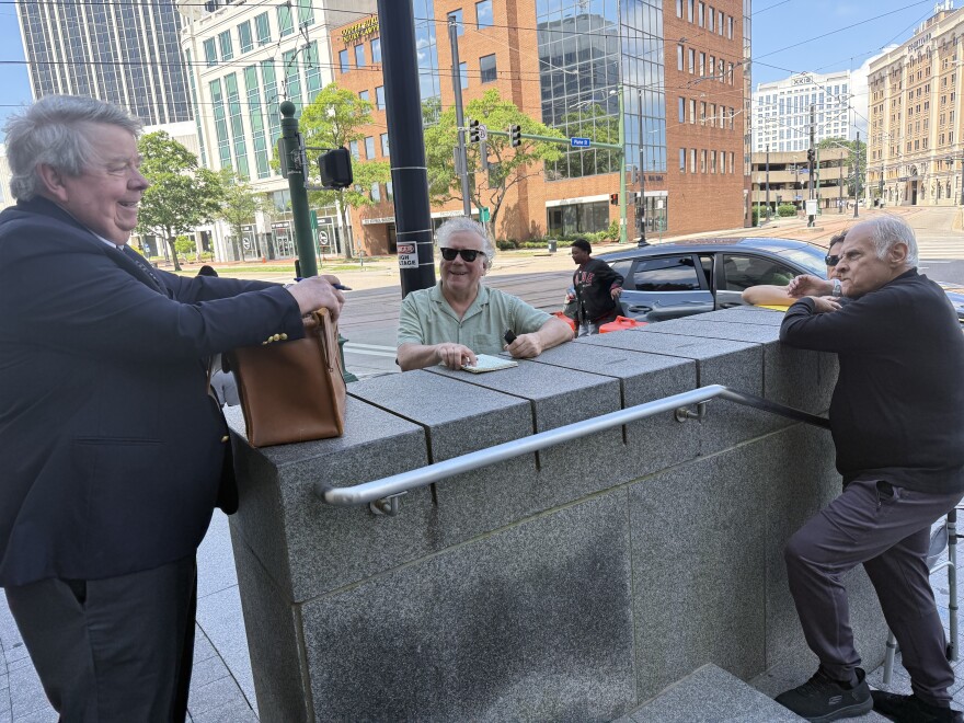 Richard Lavin stands on the bottom steps leading up to the Norfolk Circuit Court May 28, talking with David Greer, the substitute trustee who ran the auction of the Riverview Theater.