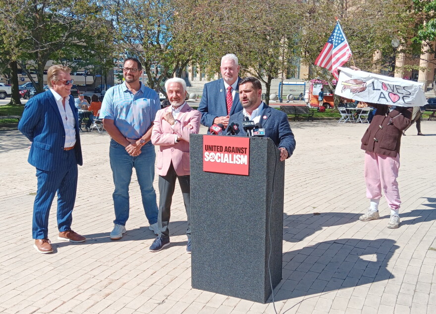 Erie County Republican Committee Chair Michael Kracker speaks in advance of a visit to Buffalo by influential New York City Democrat Alexandria Ocasio-Cortez. Joining him are, from left, Assembly candidate Frank Bogulski, former professional boxer and Democrat Joe Mesi, Erie County Conservative Chair Ralph Lorigo, and Assembly candidate Terry McGuire. A lone protestor showed up during their event.