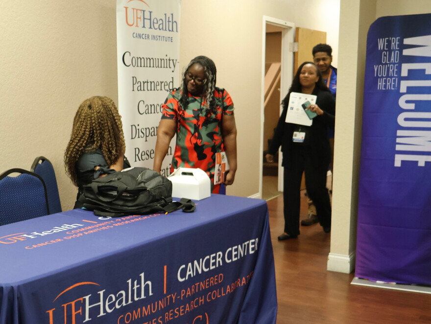 Guests are greeted at the entrance of the UF Health Cancer Institute's cancer disparities research showcase on Thursday, Oct. 22, 2026. (Emilia Hueller/WUFT News)