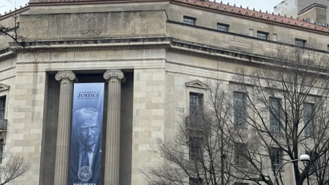 A banner showing President Donald Trump hangs on the Department of Justice on Feb. 20, 2026.