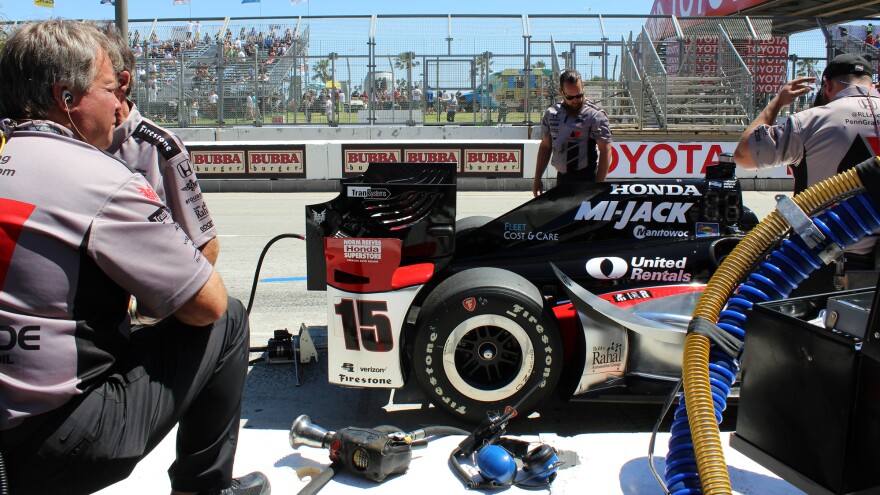Mark Bruce, left, looks on as others examine the car. Bruce is Graham Rahal's fueler, and he's had his share of close calls, like the time his fuel line broke open and ignited. "Knock on wood, I've never been on fire," he says.