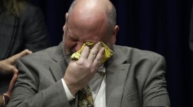 Former priest James Faluszczak, who says he was molested by a priest as a teenager, reacts as Pennsylvania Attorney General Josh Shapiro speaks during a news conference at the Pennsylvania Capitol in Harrisburg, Pa., Tuesday, Aug. 14, 2018. A Pennsylvania grand jury says its investigation of clergy sexual abuse identified more than 1,000 child victims. The grand jury report released Tuesday says that number comes from records in six Roman Catholic dioceses. (AP Photo/Matt Rourke)