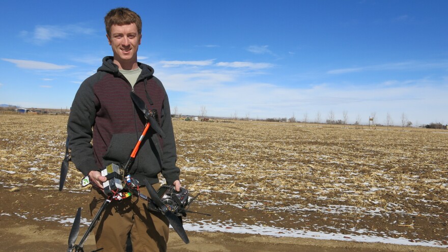 Jimmy Underhill, drone technician for Agribotix, holds a drone at a farm in rural Weld County, Colorado.