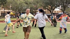 Aldo Garza, the president of the Pride Community Center and event organizer, dances with an attendee on Saturday, Oct. 3, 2026. (Madison Middleton/WUFT News