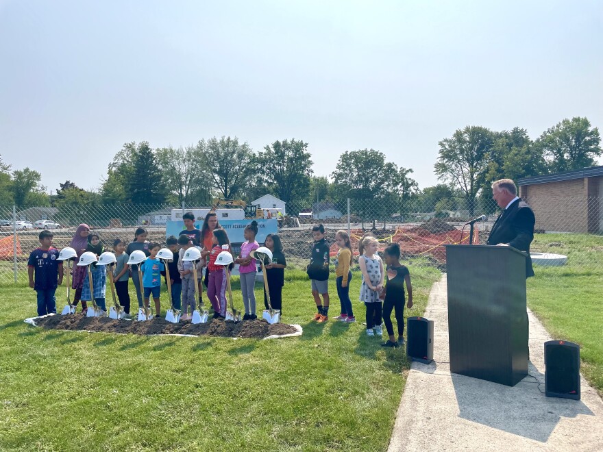 A group of Levan Scott Academy students take up a line behind a row of shovels and construction helmets to help break ground on the school's addition on Wednesday, September 14, 2022. The students are joined by principal Carrie Kennedy and Fort Wayne Community Schools superintendent Mark Daniel.