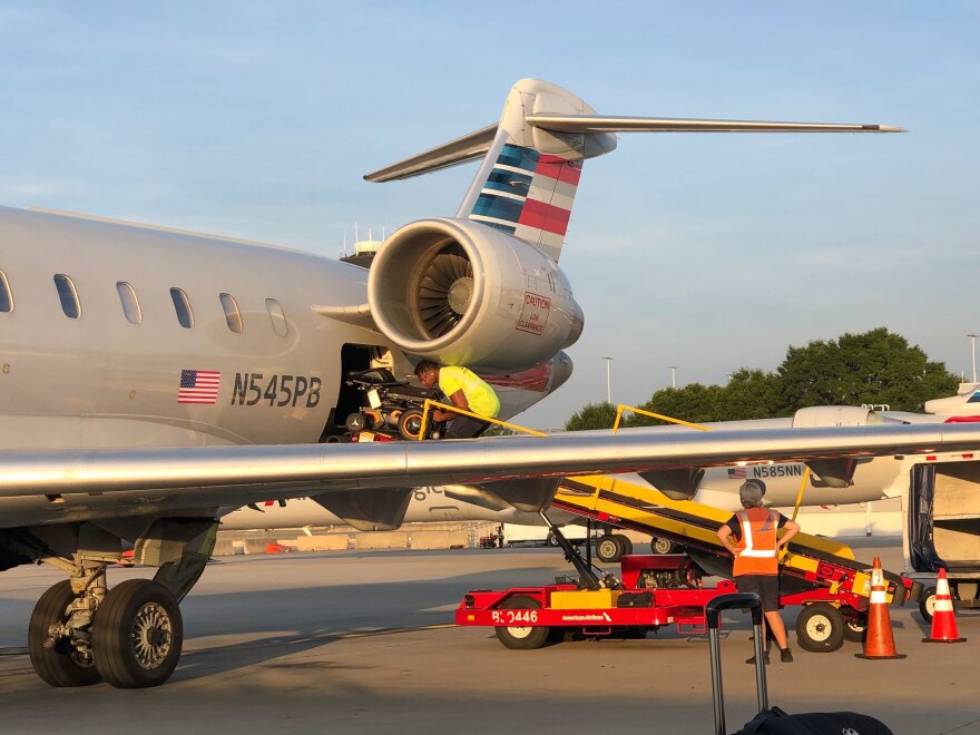 John Morris' wheelchair is loaded into an airplane.