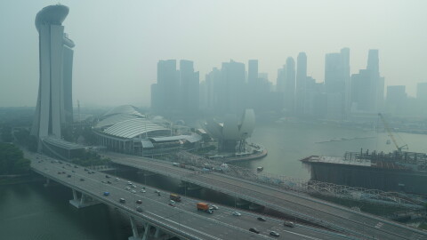 A thick haze obscures the skyline behind the Central Business District area in Singapore, Friday, Oct. 9, 2026. (AP Photo/David Hu)