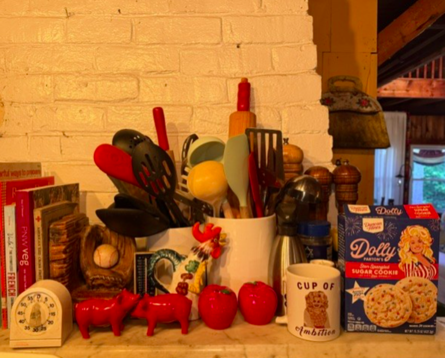 The writer's kitchen counter, featuring “a cup of ambition” and Parton-brand sugar cookie mix.