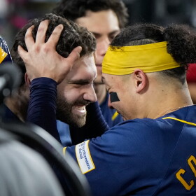 Milwaukee Brewers center fielder Garrett Mitchell celebrates his solo home run with catcher William Contreras in the dugout during the sixth inning of Game 4 of baseball's National League Championship Series between the Milwaukee Brewers and the Los Angeles Dodgers, Thursday, Oct. 15, 2026, in Los Angeles. (AP Photo/Ashley Landis)