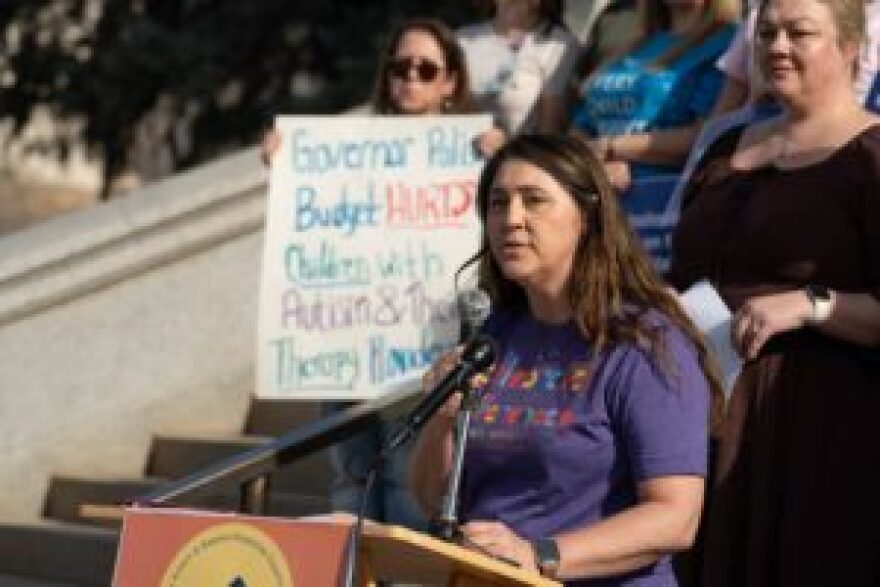 Rebecca Urbano Powell, Executive Director of Seven Dimensions Behavioral Health and president of the Colorado Association for Behavioral Analysis, urges lawmakers to preserve funding for pediatric autism therapies at a rally at the state Capitol, November 18, 2025. 