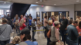 Madison County voters line up to cast early ballots at the Madison County Public Library voting center.
